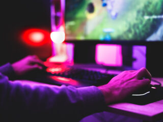 Young gamer playing online video games while streaming on social